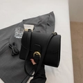 Black litchi pattern crossbody bag with golden horseshoe buckle and dual straps - Black