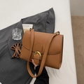 Brown litchi leather handbag with golden D-buckle and adjustable shoulder strap - Brown