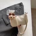 Chic off-white crescent underarm bag with a cute plush bear charm and knotted straps - Plush Bear Pendant Included / Off White