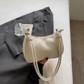 Minimalist beige dumpling bag in faux leather with silver zipper and knot strap - No Pendant / Off White