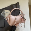 Pink leather handbag with a round handle and a cute horse charm on a minimalist background - Pink with Pendant