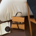 Detail of yellow and brown vintage small square handbag with golden buckle and strap - Orange