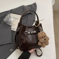 Dark brown pebble leather bucket bag with top handle and cute plush dog charm detail - Coffee with Pendant