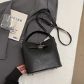Classic black PU leather handbag with adjustable strap on a grey suit background - Black without Pendant