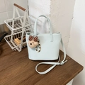 Close-up of light blue bucket bag with cute brown bear charm and colorful bead pendant - Blue with Charm