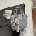 Light blue bucket bag with pearl heart and lace bow charm in a soft PU leather finish - With Pendant / Blue