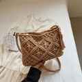 Close-up of handmade woven cotton bag showing geometric texture, tassels and metal zipper - Khaki