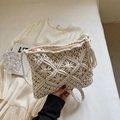 Detailed macro view of cream macrame shoulder bag with fringe tassel and zipper - White