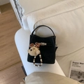 Elegant black matte suede bucket bag with stylish metal turn-lock and ribbon charm - With Charm / Black