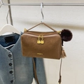 Brown faux suede pillow shoulder bag with gold hardware and plush pompom charm - Brown
