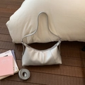 Detailed macro view of silver lychee texture on crescent shoulder bag with strap - Silver