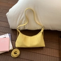 Detail of yellow lychee grain leather crescent bag with stitching and silver hardware - Yellow