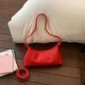 Detail view of the red lychee pattern leather shoulder bag with pleated texture and strap - Red