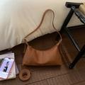 Detail view of large brown lychee texture leather hobo bag with metal buckle and zipper - Brown