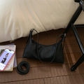 Detail of black lychee texture bag with silver hardware and adjustable shoulder strap - Black