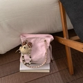 Detailed shot of pink quilted bucket bag with pearl chain and cute teddy bear charm - Pink with Pendant