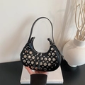Black leather hobo shoulder bag with silver rivet studs in a stylish minimalist setting - Black