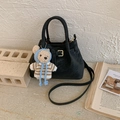 Detail of black matte bucket bag featuring leather buckle and a cute teddy bear charm - Black With Pendant