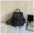 Detail of a black lychee texture leather backpack with flap cover and metal buckle - Black