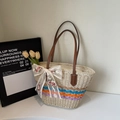 Detail of hand-woven straw tote bag with white lace bow and floral embroidery motif - Off-white