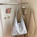 Minimalist canvas tote bag with pixelated pattern and light blue strap in soft lighting - Blue Without Charm
