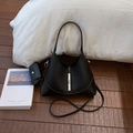 Detail of black crescent bucket bag with lychee texture leather and silver metal buckle - Black