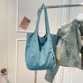 Detail of Morandi blue nylon tote bag showing side woven label and wide shoulder straps - Lake Blue
