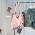 Detailed close-up of a light pink minimalist tote bag made of durable nylon material - Pink
