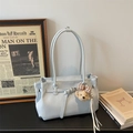 Close-up of light blue faux leather tote bag with lychee texture and bear charm - With Charm / Blue
