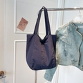 Detail view of deep blue nylon tote bag with front pocket and double handles - Navy Blue