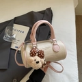 Detail view of cream white cylinder bag with pink handles and cute plush bear charm - Pink (With Plush Charm)