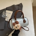 Detail of light blue Boston bag with brown handles and a cute teddy bear charm - Blue (With Plush Charm)
