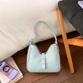 Detailed view of light blue hobo bag featuring silver metal buckle and soft PU leather - Blue