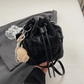 Minimalist black drawstring bucket bag featuring a textured finish and cute plush bear charm - With Charm / Black