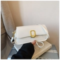 Detail of white square shoulder bag featuring gold metallic clasp and matte leather texture - White