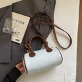 Light blue and brown cylinder pillow bag with adjustable shoulder strap and top handle - Blue