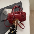 Deep red bowling handbag in smooth PU leather with adjustable crossbody strap and charm - With Charm / Red