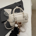 Chic beige crossbody bowling bag with decorative horse charm and gold buckle - With Charm / Off White