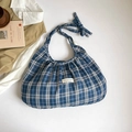 Blaue karierte Stofftasche mit Schleifen-Detail und Etikett in einer Flatlay-Ansicht - Blau