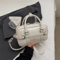 Elegant cream white bowling bag with silver buckle and crossbody strap on gray blazer - No Pendant / Off White