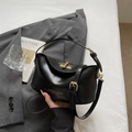 Classic matte black leather handbag with gold hardware and adjustable crossbody strap - Black