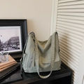 Detailed view of the olive green nylon tote bag with functional pockets and wide strap - Green
