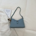 Chic light blue leather bucket bag with silver heart charm and metal twist lock detail - Blue with Pendant