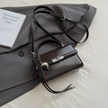 Glossy dark coffee square handbag with silver clasp and heart charm on gray jacket - Coffee with Heart Charm