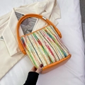 Woven bucket bag with orange leather trim and colorful vertical stripes on off-white fabric - Orange