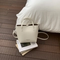 Minimalist beige bucket bag with dual handles and adjustable strap on a cozy background - White Without Pendant