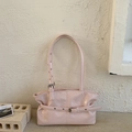 Detail of light pink wrinkled patent leather tote bag featuring silver metal buckle accents - Pink