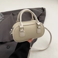 Chic off-white pebble grain mini bowling bag with dual handles and slim shoulder strap - No Pendant / Off White