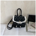 Detalle de mini mochila negra de lunares con ribete de encaje blanco y colgante de corazón - Negro