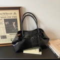 Minimalist black glossy leather tote bag with silver buckle and elegant pleated design - Black